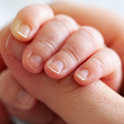 Mother holding baby's hand