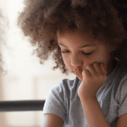 Young girl looking apprehensive while speaking to health visitor