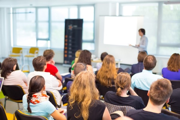 A group of people listening to a presentation.