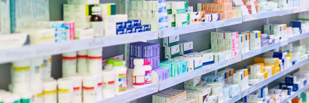 shelves in a pharmacy with a selection of prescription drugs