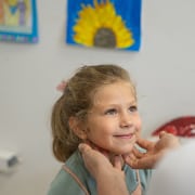 Female clinician examining little girl in clinic