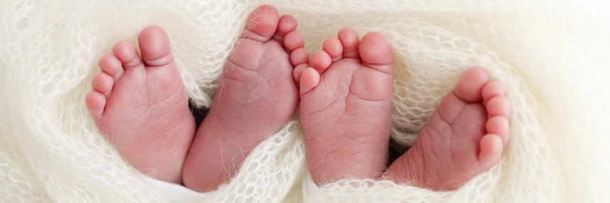 Two identical pairs of baby feet.