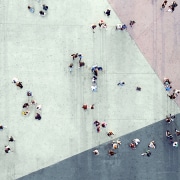 Aerial photograph of a crowd walking across a plaza