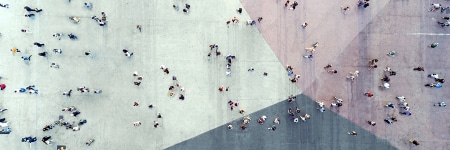 Aerial photograph of a crowd walking across a plaza