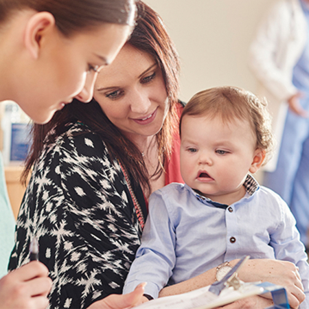 Mother and young child with nurse