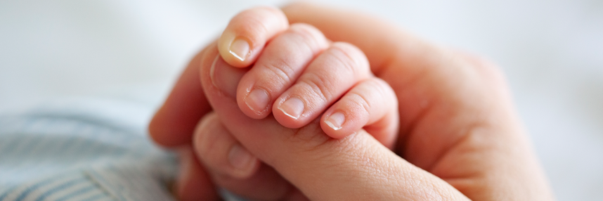 Mother holding baby's hand