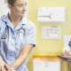 A pregnant woman is examined by a student midwife overseen by a senior team member