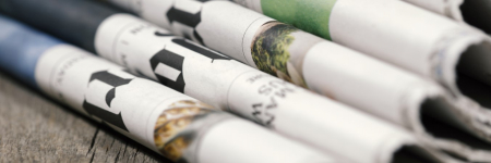 A pile of folded newspapers