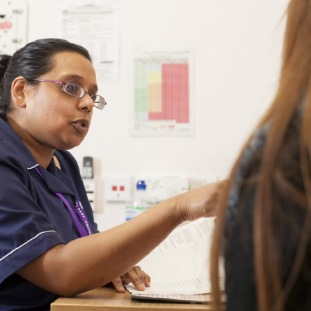 Nurse talking to female patient