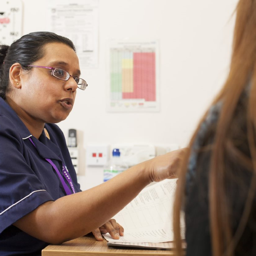 Nurse talking to female patient