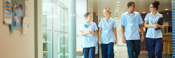 A group of nurses walking through a hospital