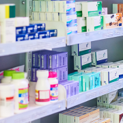 shelves in a pharmacy with a selection of prescription drugs