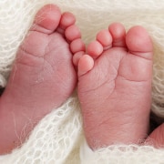 Two identical pairs of baby feet.